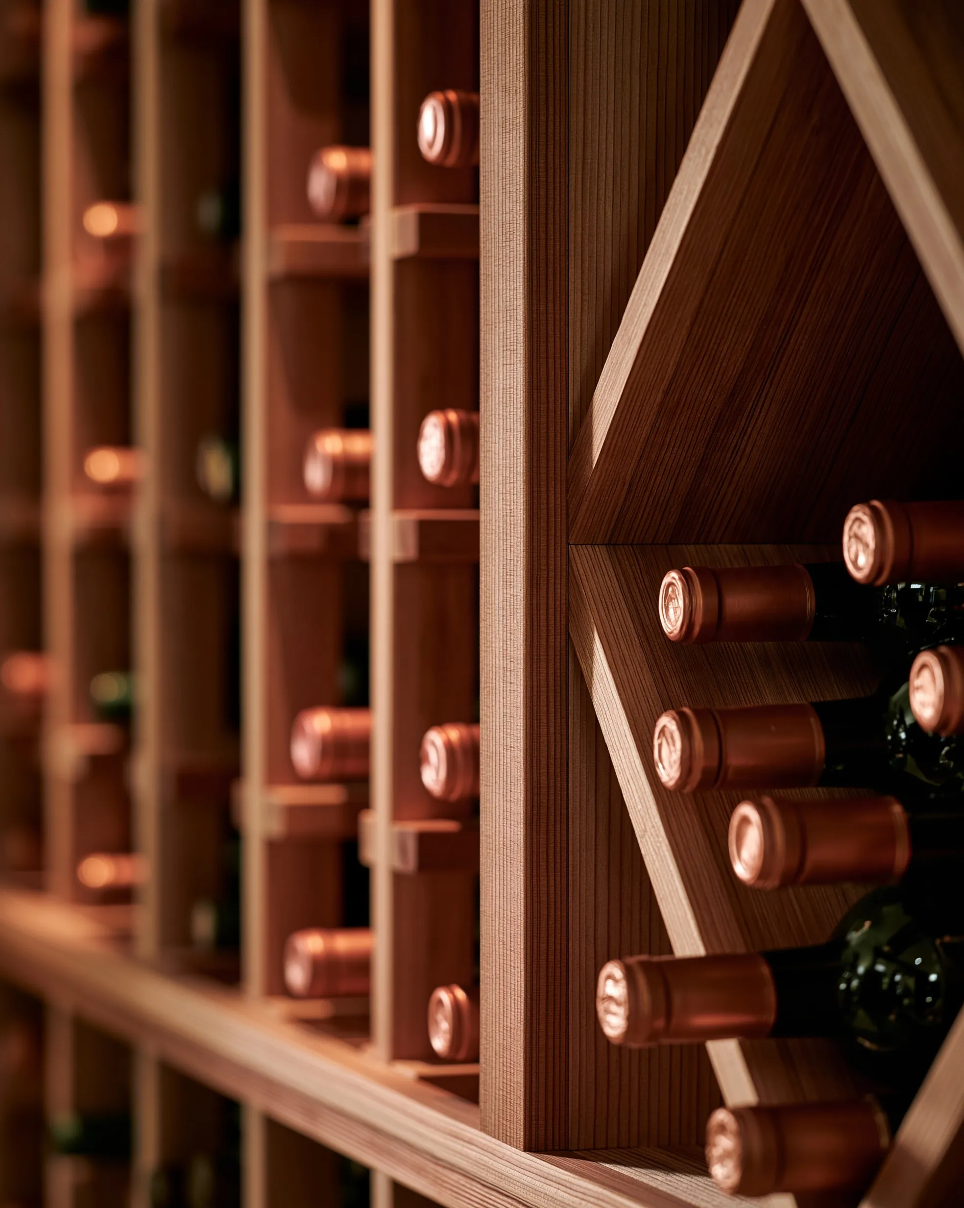 Close view of light wood individual bottle slots beside a diamond bin stacked with bottles